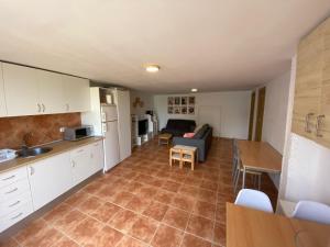 a kitchen and living room with a couch and a table at La Novelera in Echedo +4 photos