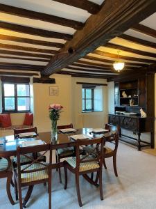 a dining room with a wooden table and chairs at The Farmhouse in Teignmouth