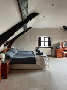 a bedroom with a large bed in a attic at The Farmhouse in Teignmouth