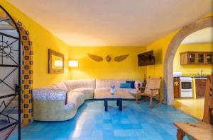a living room with a couch and a table at Business in-suite with office in San Miguel de Allende