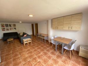 a living room with a couch and a table and chairs at La Novelera in Echedo