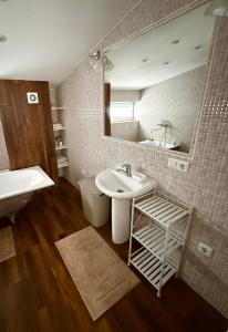 a bathroom with a sink and a mirror at CENTRO House in Alytus +40 photos