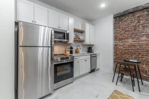 a kitchen with stainless steel appliances and a brick wall at Park Hotel Studio Suite 307 in Chattanooga