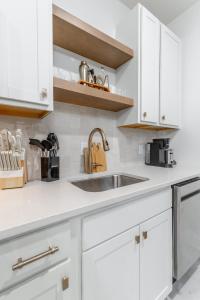 a kitchen with white cabinets and a sink at Park Hotel Studio Suite 307 in Chattanooga