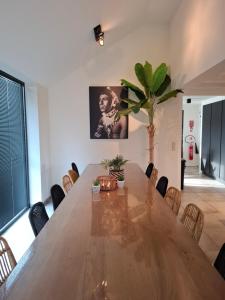 a dining room with a large wooden table and chairs at Landhuys Odette in Retie