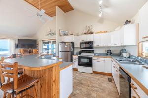 a kitchen with white cabinets and a counter top at Ocean Wynns - Nags Head MP 13, 20 Yards to the Beach, Ocean Views, Close to Attractions in Nags Head