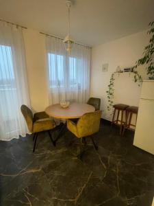 a living room with a table and chairs and a kitchen at Danube in Vukovar