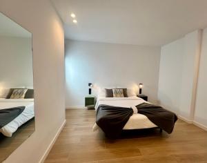 a bedroom with two beds and a hallway at La Cala de Alcalá Luxury in Alcalá