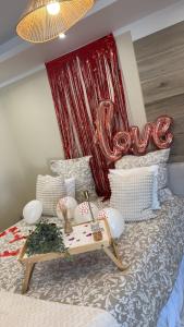 a room with a bed with a sign that says love at Studio t1 in Mornas