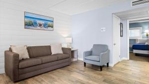 a living room with a couch and a chair at Beachfront WW Crest Condo Sleeps 6 in Wildwood Crest