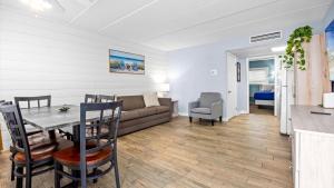 a living room with a couch and a table at Beachfront WW Crest Condo Sleeps 6 in Wildwood Crest