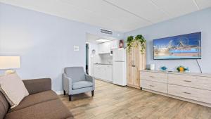 a living room with a couch and a kitchen at Beachfront WW Crest Condo Sleeps 6 in Wildwood Crest