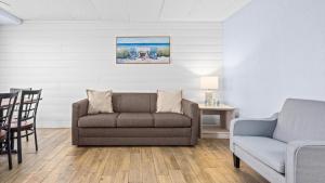 a living room with a couch and a chair at Beachfront WW Crest Condo Sleeps 6 in Wildwood Crest +22 photos