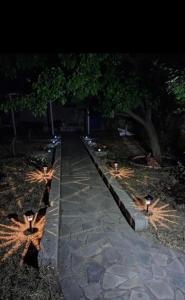 a walkway with lights in a park at night at Sunny Home in Anaxos
