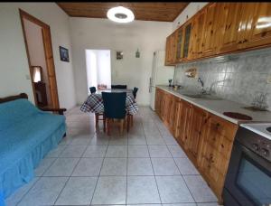 a kitchen with a sink and a table with chairs at Sunny Home in Anaxos