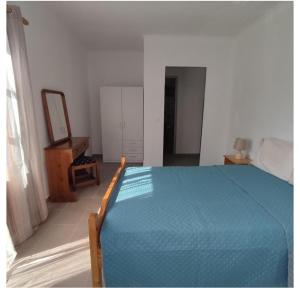 a bedroom with a bed and a mirror and a dresser at Sunny Home in Anaxos
