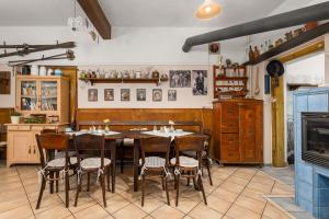 a dining room with a table and chairs at U Hudečků in Zadov