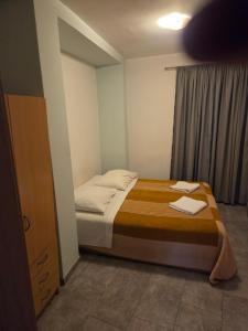 a bedroom with a bed with two towels on it at Apartment Central in Šibenik
