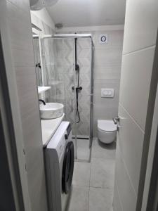 a bathroom with a shower and a toilet and a sink at Apartment Central in Šibenik +40 photos