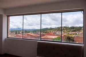 a large window with a view of a city at Hospedaje Tikari in Chincheros