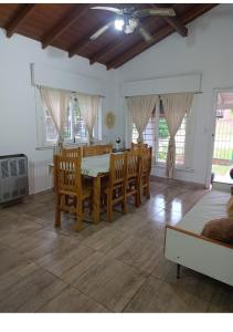 a dining room with a table and chairs at Nafaro in Villa Gesell