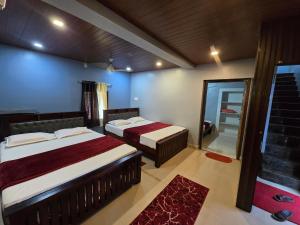 a hotel room with two beds and a mirror at Ayodhya Home stay in Māvalli