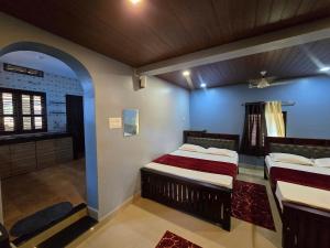 two beds in a room with blue walls at Ayodhya Home stay in Māvalli +30 photos