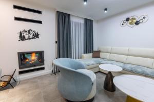 a living room with a couch and a fireplace at Golden peak Blidinje in Blidinje