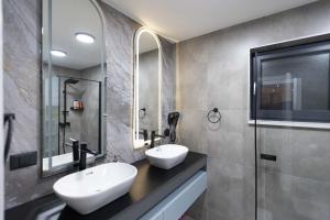a bathroom with two sinks and a shower at Golden peak Blidinje in Blidinje +39 photos