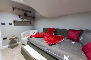 a bedroom with a bed with red pillows at Golden peak Blidinje in Blidinje