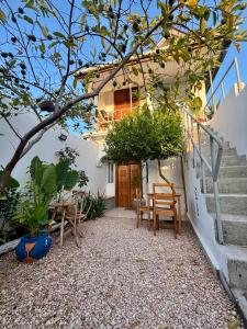 a house with a staircase and a table and chairs at Samia House in Jambiani