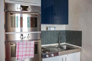 a kitchen with a stainless steel stove and a sink at Cà Fede in Venice
