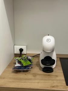 a coffee maker sitting on top of a wooden floor at Grelios stanze preziose in Guardiagrele