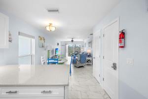 a kitchen with a counter and a dining room at Seashells Unit 44 in Sanibel