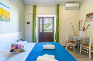 a bedroom with a blue bed and a table at Casacecilia relax in Syracuse
