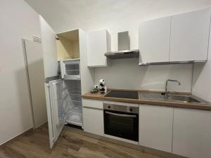 a small kitchen with white cabinets and a sink at Grelios stanze preziose in Guardiagrele