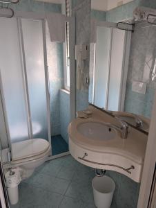 a bathroom with a sink and a toilet at Hotel Villa Lieta in Rimini +39 photos