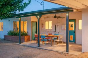 a patio with a table and chairs on it at Joshua Tree Mid Mod - Pool - Spa - Sauna - Fire pit in Yucca Valley