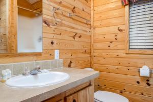 a bathroom with a sink and a toilet at Yosemite Lakes Cabin & Cottages in Harden Flat +29 photos
