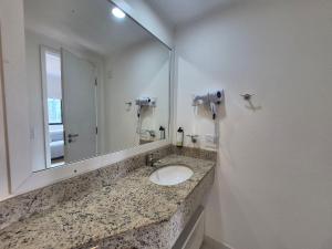 a bathroom with a sink and a large mirror at Flat Vila Mariana Ibirapuera (Apto 1005) in São Paulo +26 photos