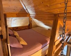 a bunk bed in a wooden cabin at Lozanski ambar in Boljevac +16 photos