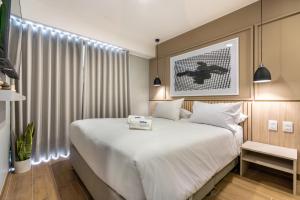 a bedroom with a large bed with white sheets at Ejército City Lofts & Apartments by Geko in Lima +56 photos