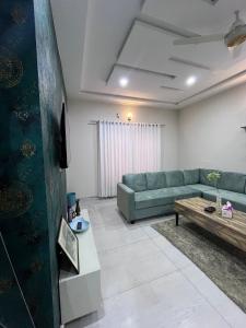 a living room with a couch and a coffee table at Livora stays Cozy Luxury 1BHK in Multan