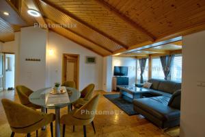 a living room with a couch and a table and chairs at Rustica Apartments in Maribor