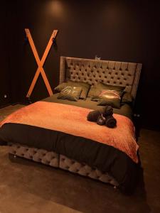 a bedroom with a large bed with a wooden headboard at Cc love in Carbonne