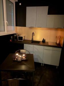 a kitchen with a table with candles on it at Cc love in Carbonne +9 photos