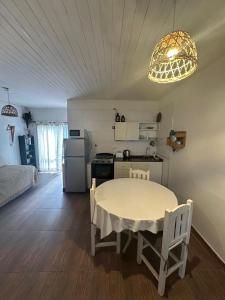 a kitchen with a white table and a white refrigerator at Exclusivo Apartamento Centro Laguna in Chascomús
