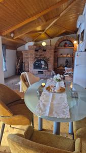 a dining room with a glass table and chairs at Rustica Apartments in Maribor