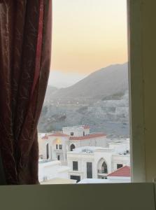 a view of a city from a window at Stay home in ‘Uqayr +9 photos