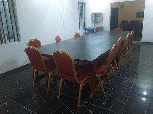 a conference room with a wooden table and chairs at Crown Dove in Benin City